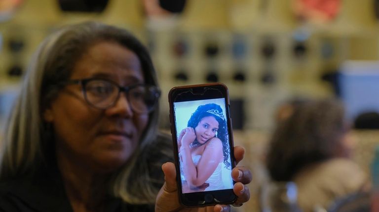 Rosa Hernández shows a photo of her late daughter Rosaura...