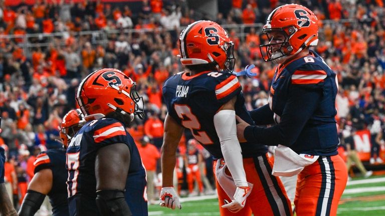 Syracuse wide receiver Trebor Pena (2) and quarterback Kyle McCord...