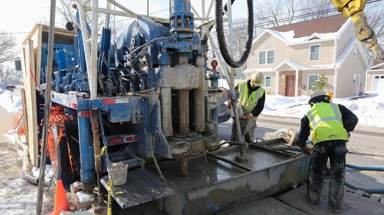 Northrop Grumman contractors drill at the corner of William Street...