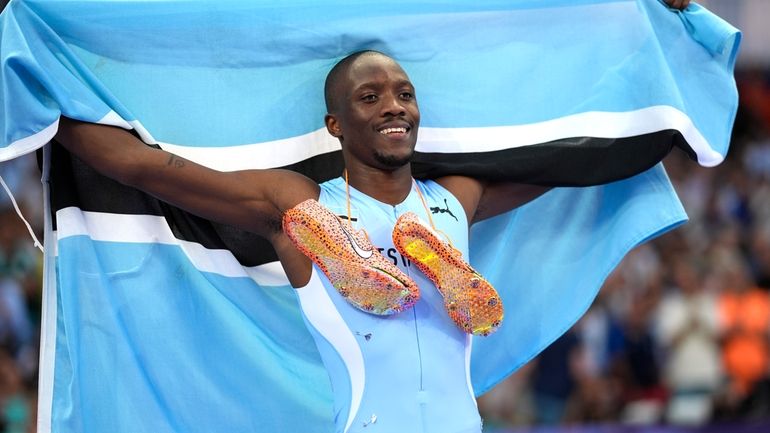 Letsile Tebogo, of Botswana, celebrates after winning the men's 200-meter...