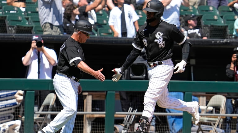 Chicago White Sox's Luis Robert Jr., right, celebrates with third...