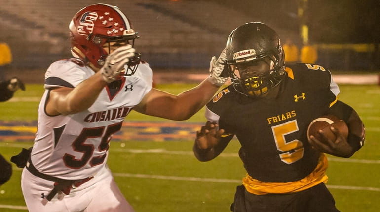 St. Anthony's Sean Bryan (5) runs the ball during the...