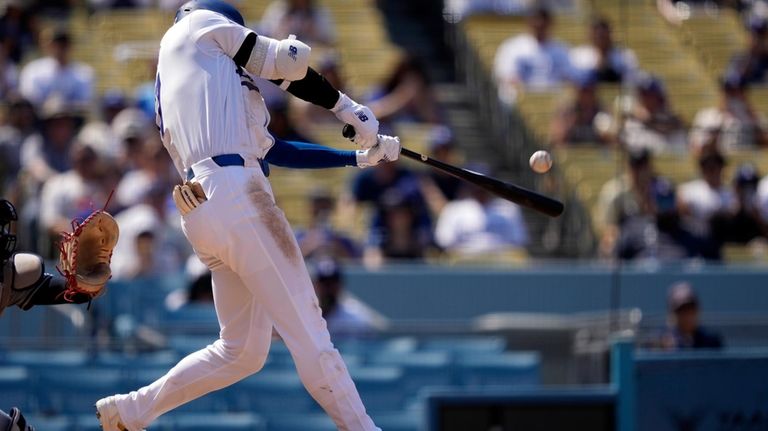 Los Angeles Dodgers' Shohei Ohtani hits a solo home run...