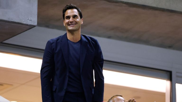 Tennis great Roger Federer acknowledges the crowd during the quarterfinal...