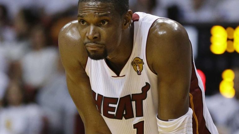 Miami Heat center Chris Bosh pauses during the first half...