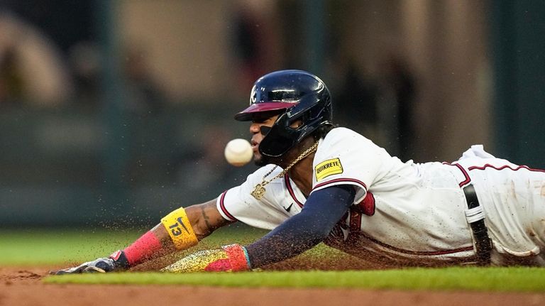 Atlanta Braves right fielder Ronald Acuna Jr. beats the throw...