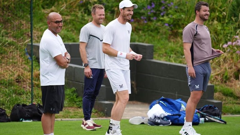 Britain's Andy Murray and his coaching team on the practice...