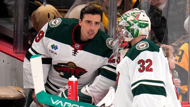 Minnesota Wild goaltender Filip Gustavsson (32) talks with Marc-Andre Fleury...