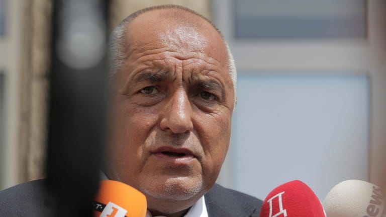 Bulgarian former Prime Minister Boyko Borissov talks to media after...