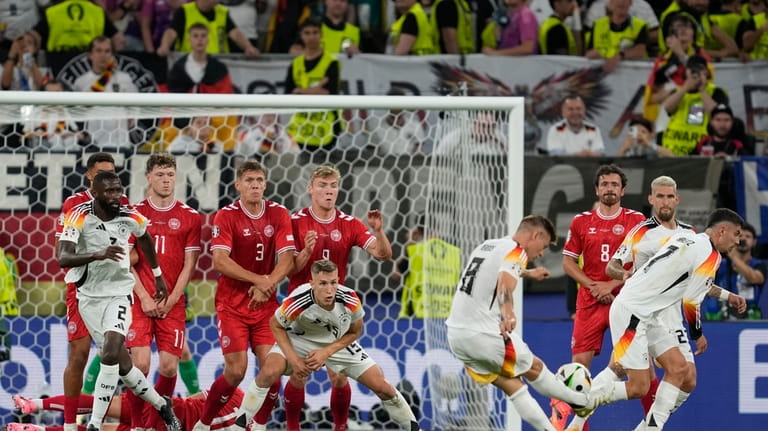 Germany's Toni Kroos (8) takes a free-kick against Denmark during...