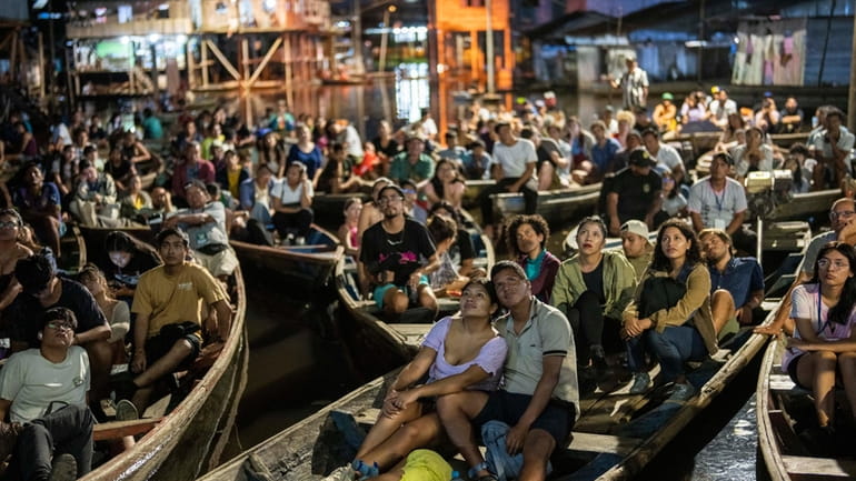 Spectators watch a film from boats during the Muyuna Floating...