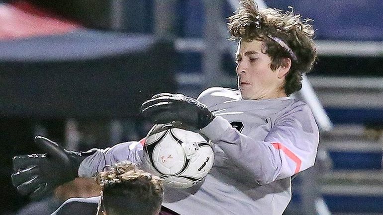 Garden City goalie Joe Griffin makes a save during the...