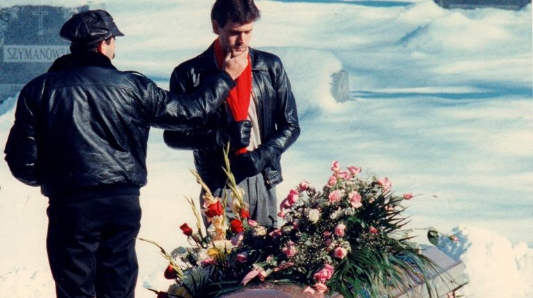 Matthew Solomon stands at the coffin of his wife Lisa Solomon...