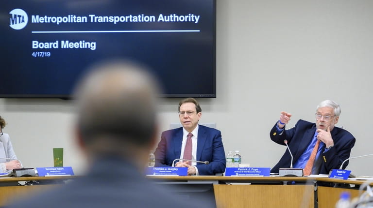Patrick Foye, right, presides over his first MTA meeting as chairman...