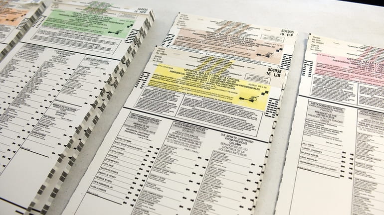 Colored coordinated Presidential Primary Election ballots are organized by political...