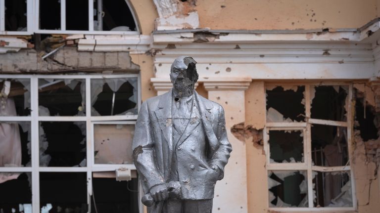 A damaged monument to Soviet founder Vladimir Lenin stands in...