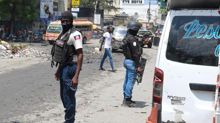National Police patrol an intersection amid gang violence in Port-au-Prince,...