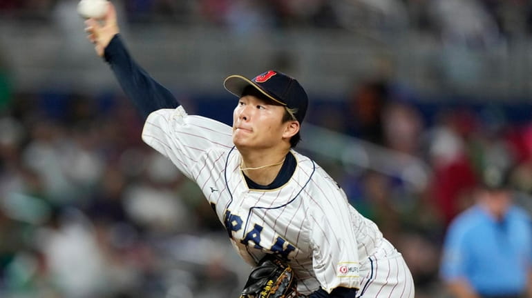 Yoshinobu Yamamoto delivers a pitch during the fifth inning of...