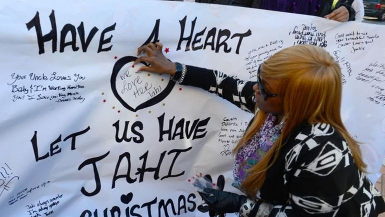 Dede Logan of Oakland, Calif., decorates a poster in support...