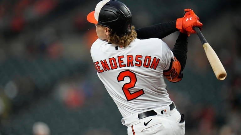 Baltimore Orioles' Gunnar Henderson follows through on a swing while...