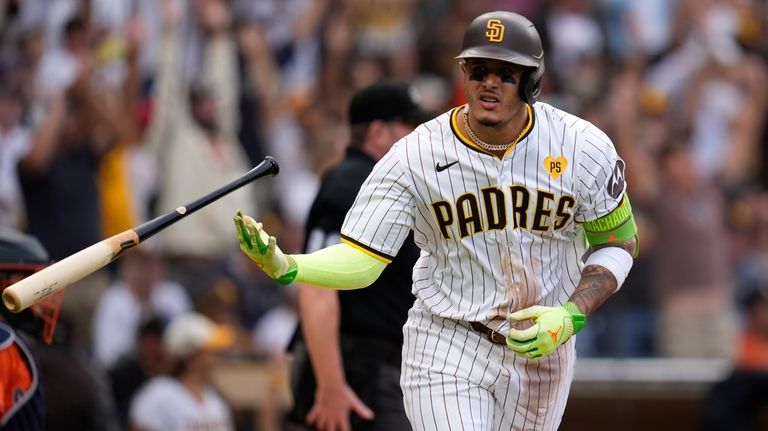 San Diego Padres' Manny Machado tosses his bat after hitting...