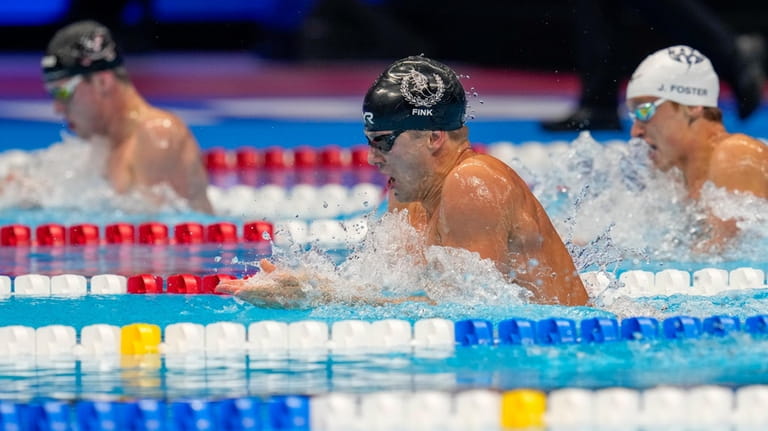 Nic Fink swims during the Men's 100 breaststroke finals Sunday,...