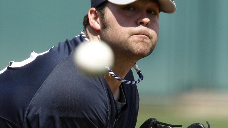 Yankees pitcher Joba Chamberlain delivers against the Detroit Tigers during...