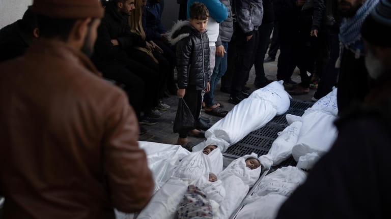 Palestinians mourn their relatives, including kids killed in the Israeli...