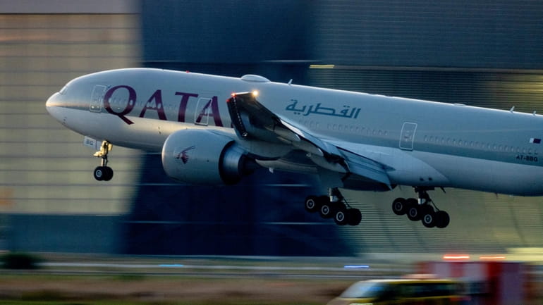 A Qatar airways plane lands at the airport in Frankfurt,...