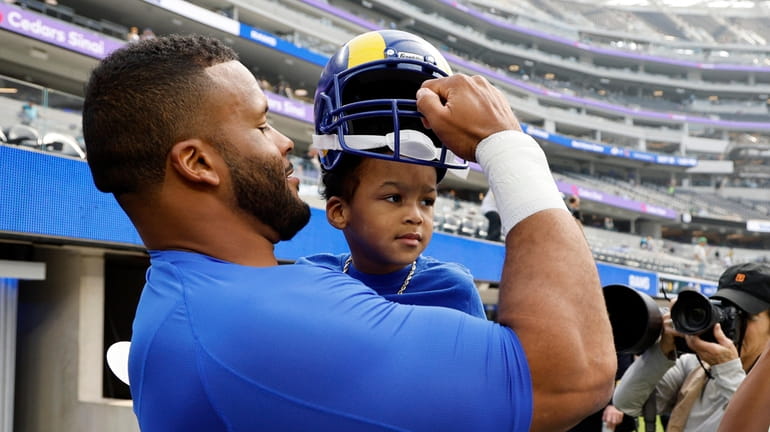 Los Angeles Rams defensive tackle Aaron Donald spends a few...