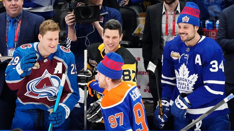 Edmonton Oilers' Connor McDavid is congratulated by Colorado Avalanche's Nathan...