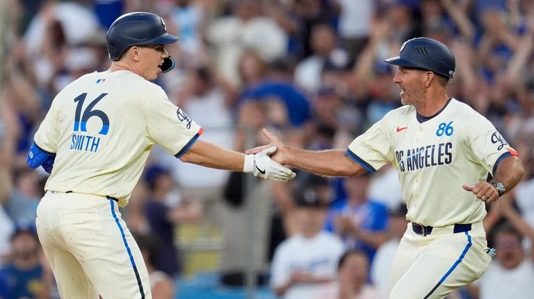 Los Angeles Dodgers' Will Smith, left, celebrates with first base...