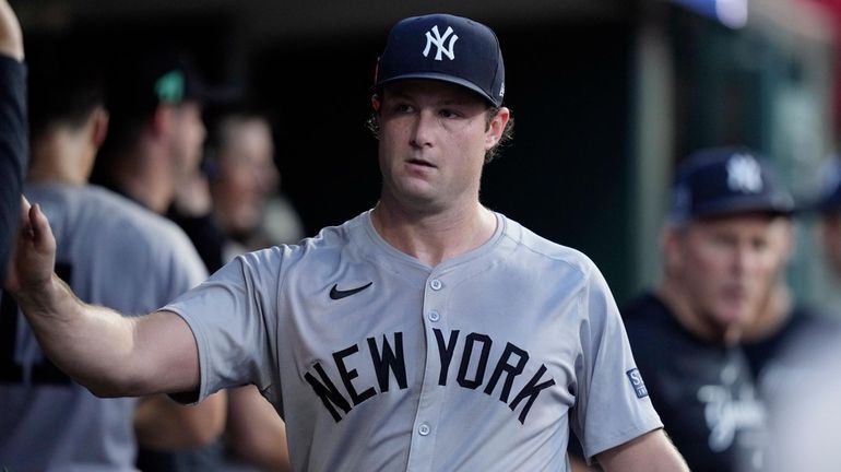 Yankees starting pitcher Gerrit Cole greets teammates after the sixth...