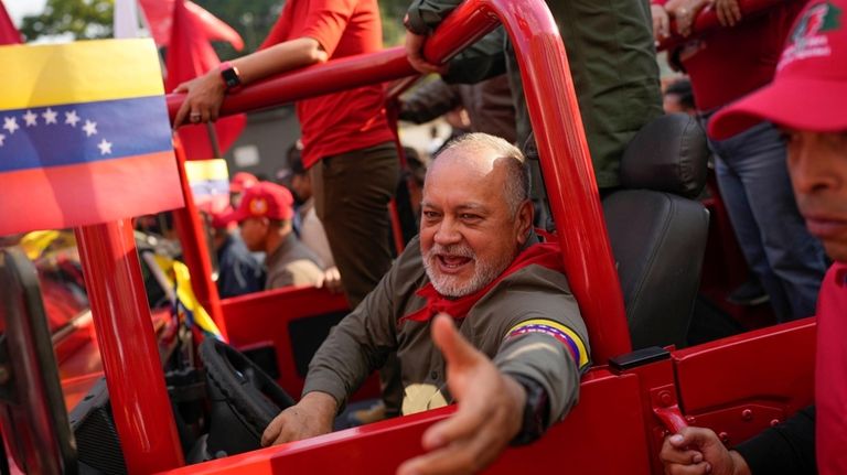 Venezuelan politician Diosdado Cabello greets supporters during an event marking...