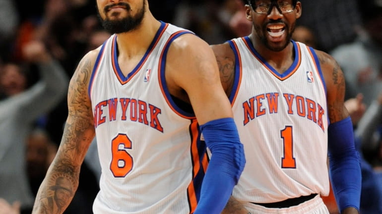 Knicks' Amar'e Stoudemire, right, smiles as Tyson Chandler reacts after...