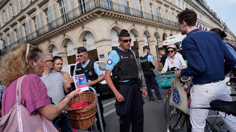 Police officers check authorizations at a checkpoint, July 18, 2024,...