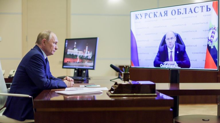 Russian President Vladimir Putin, left, listens to acting Gov. Alexei...