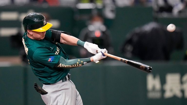 Robert Perkins of Australia hits a 3-run home rung off...