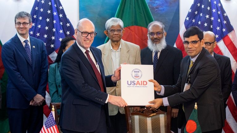 Reed J. Aeschliman, USAID Mission Director for Bangladesh, front left,...