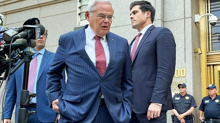 U.S. Sen. Bob Menendez, D-N.J., center, leaves federal court following...