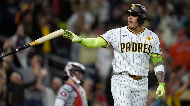 San Diego Padres' Manny Machado tosses his bat after hitting...