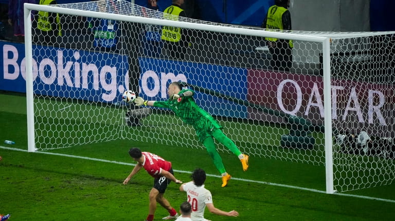 Turkey's goalkeeper Mert Gunok saves the ball during a round...