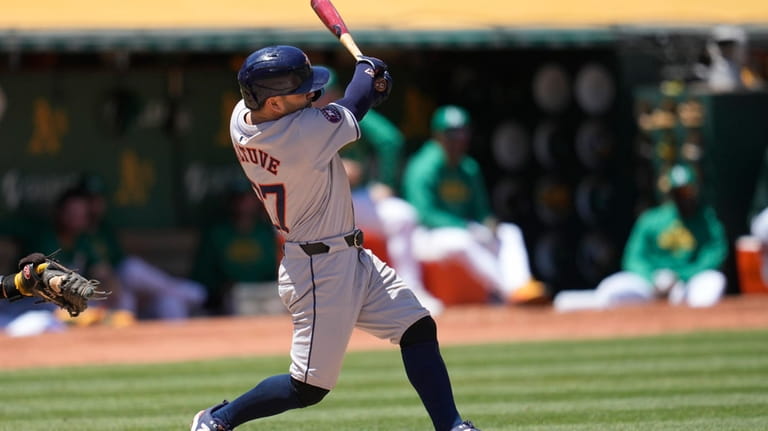 Houston Astros' Jose Altuve hits a two-run single against the...