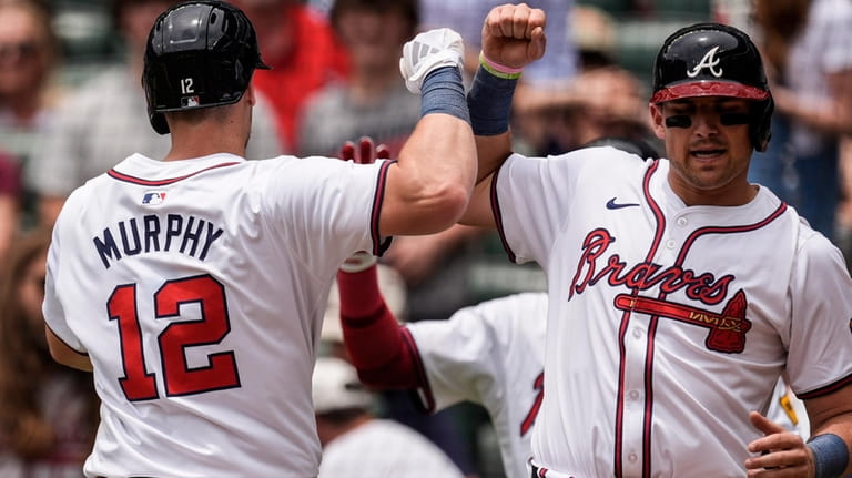 Atlanta Braves' Sean Murphy (12) celebrates his two-run homer against...