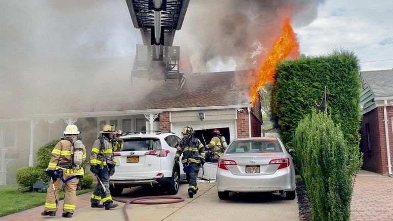 A fire rages in a house on Meadow Street in Garden...