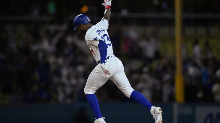 Los Angeles Dodgers Jason Heyward (23) rounds the bases after...