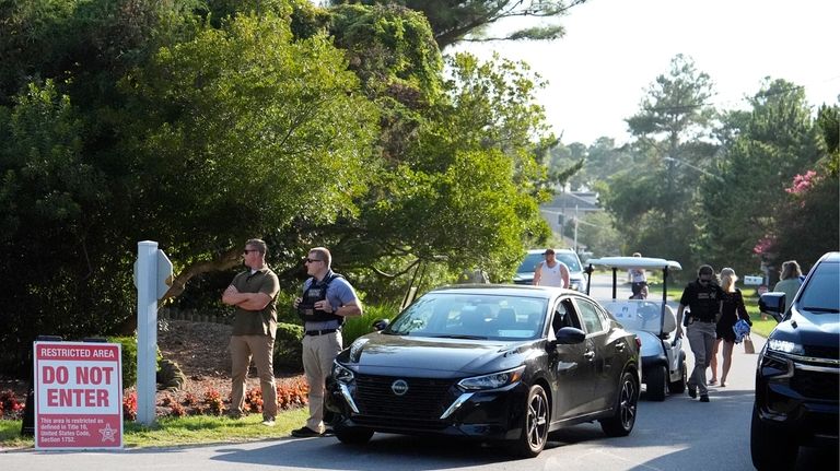 Law enforcement blocks off a street near President Joe Biden's...