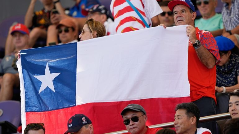 A Chilean supporter holds up a flag ahead of the...