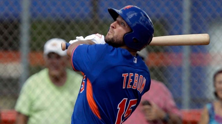 Tim Tebow hits a solo home run in his first...