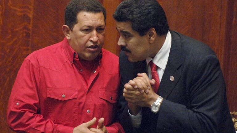 Venezuela's President Hugo Chavez, left, talks to then Foreign Minister...